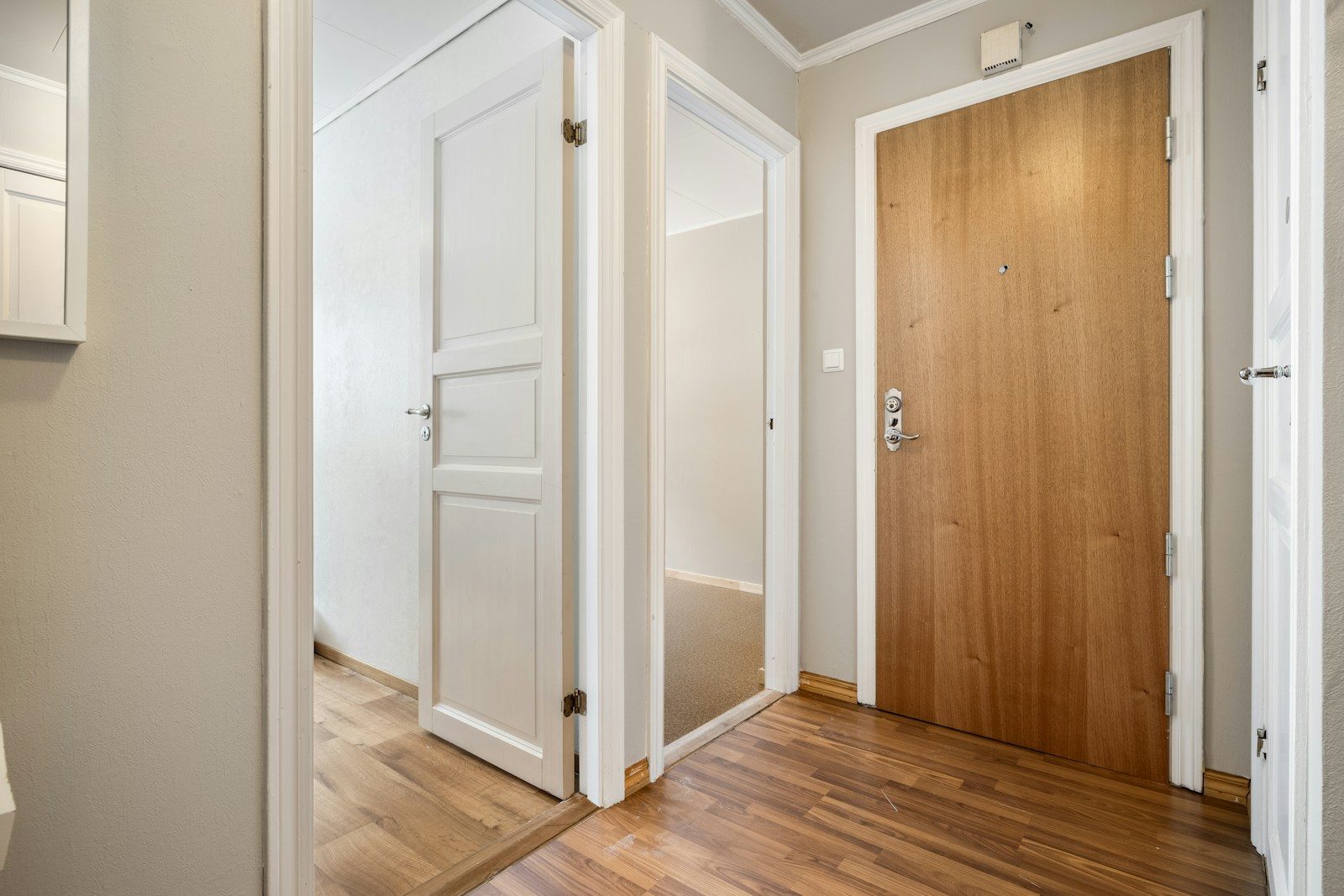 A bathroom with a toilet and a wooden door