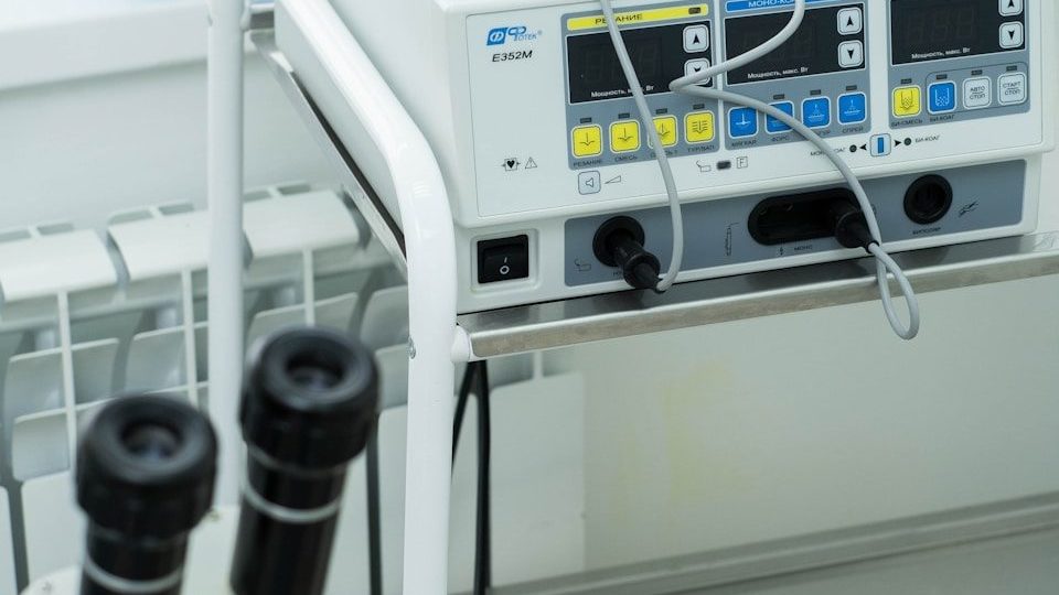 a medical machine with two microscopes on top of it